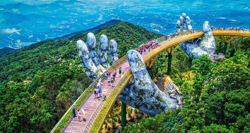 Two barms arising from the mountains holding the bridge