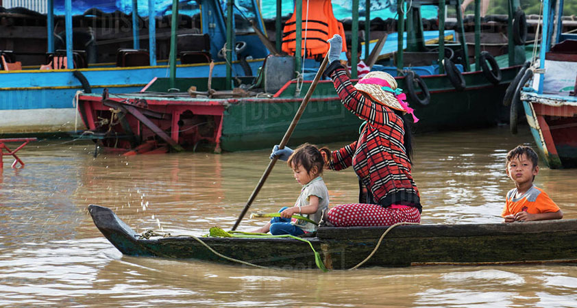 Woman and children in a boat on the Tonle Sap, Siem Reap