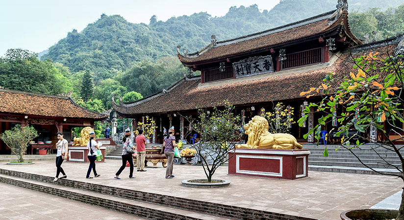 Take a sampan boat on a peaceful river to reach Huong perfume